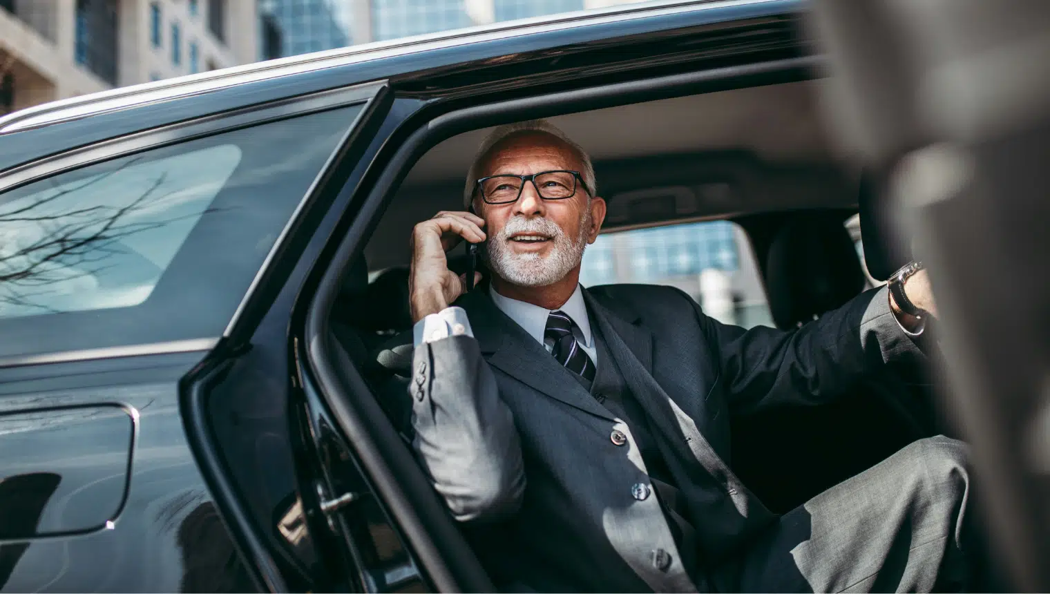 Executive professional exiting luxury vehicle