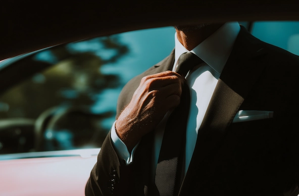 Chauffeur with luxury SUV at private airport